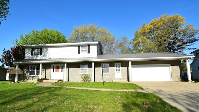 536 3rd Ave, Wanamingo, MN 55983 - view of front of property with an attached garage, brick siding, concrete driveway, a front lawn, and metal roof