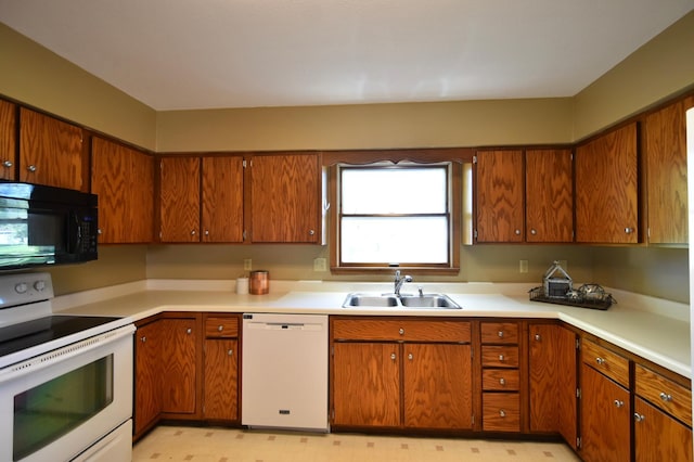 536 3rd Ave, Wanamingo, MN 55983 - kitchen featuring white appliances, a sink, light countertops, and brown cabinetry