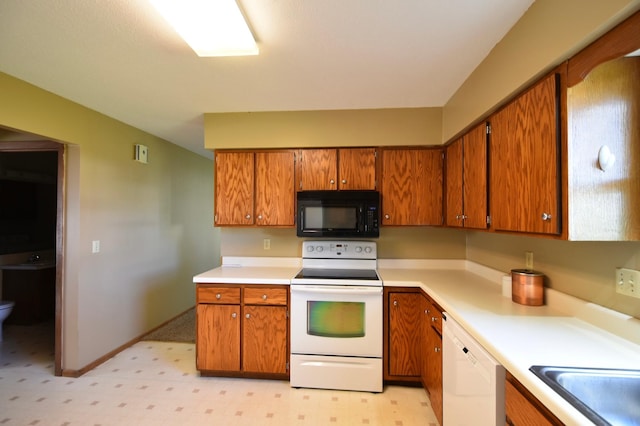 536 3rd Ave, Wanamingo, MN 55983 - kitchen with white appliances, brown cabinets, light countertops, light flooring, and a sink