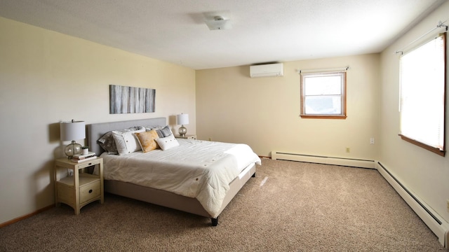 536 3rd Ave, Wanamingo, MN 55983 - bedroom with a wall unit AC, a baseboard radiator, and carpet