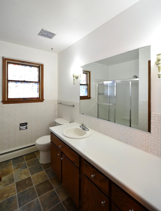 536 3rd Ave, Wanamingo, MN 55983 - full bathroom with healthy amount of natural light, baseboard heating, a stall shower, vanity, and wainscoting