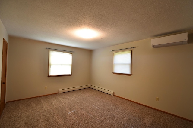 536 3rd Ave, Wanamingo, MN 55983 - carpeted empty room with a wall mounted AC, baseboard heating, a textured ceiling, and baseboards
