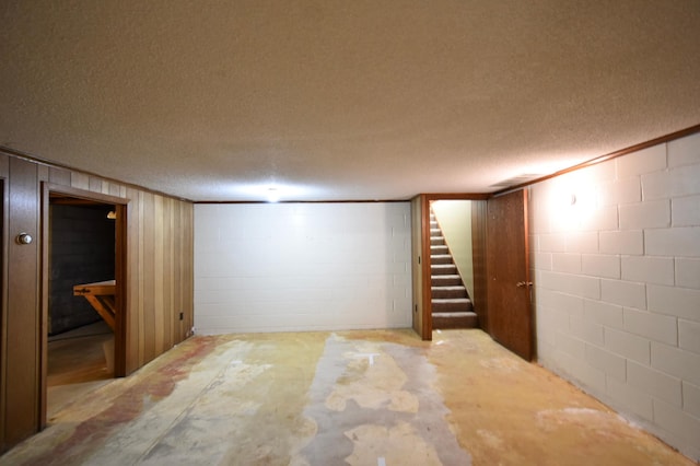 536 3rd Ave, Wanamingo, MN 55983 - finished basement with a textured ceiling, concrete block wall, and stairway