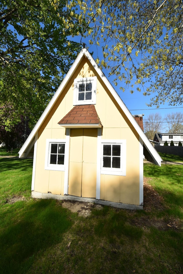 536 3rd Ave, Wanamingo, MN 55983 - rear view of house with a yard and roof with shingles