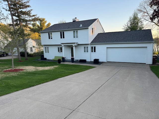 view of front of house featuring a garage, driveway, a chimney, a front yard, and roof with shingles