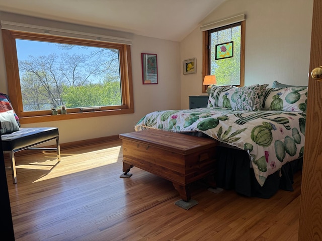 bedroom featuring lofted ceiling and wood finished floors