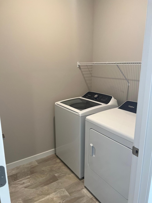 12515 Erskin St NE, Blaine, MN 55449 - laundry room featuring washing machine and dryer, light wood finished floors, and baseboards