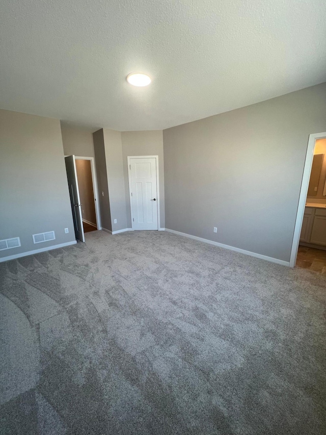 12515 Erskin St NE, Blaine, MN 55449 - unfurnished bedroom featuring carpet floors, baseboards, and a textured ceiling