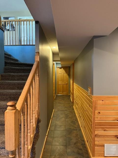 hallway with dark tile patterned floors
