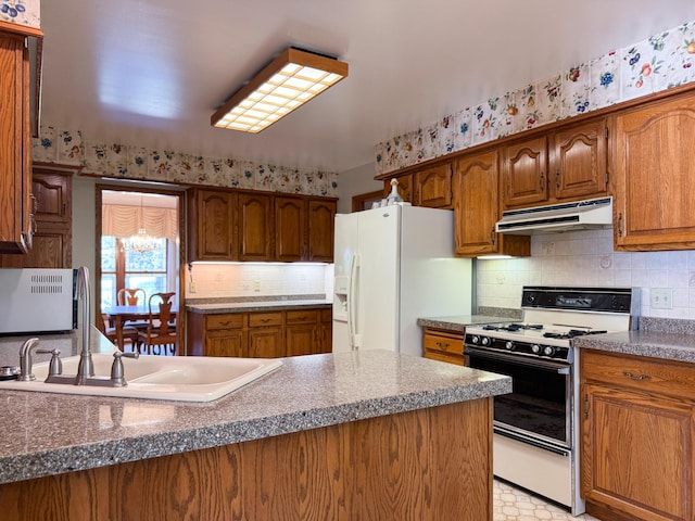 1626 Diane Rd, Mendota Heights, MN 55118 - kitchen with gas range, under cabinet range hood, white fridge with ice dispenser, a sink, and brown cabinetry