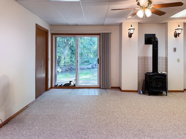 1626 Diane Rd, Mendota Heights, MN 55118 - unfurnished living room with a wood stove, a ceiling fan, carpet floors, baseboards, and a paneled ceiling