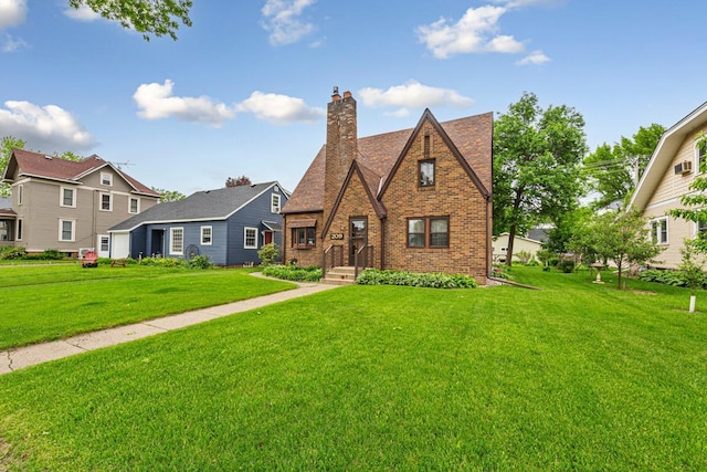 209 Main St, Arlington, MN 55307 - view of front of property with a front lawn, a chimney, and brick siding