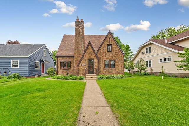 209 Main St, Arlington, MN 55307 - tudor-style house with brick siding, a front lawn, and a chimney