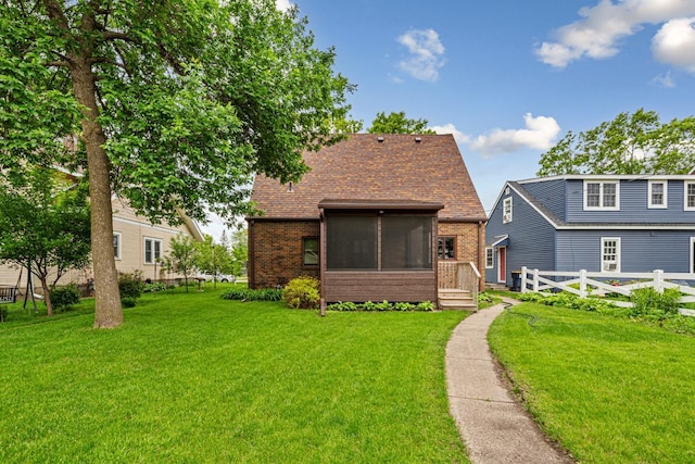 209 Main St, Arlington, MN 55307 - rear view of property with a sunroom, brick siding, and a shingled roof