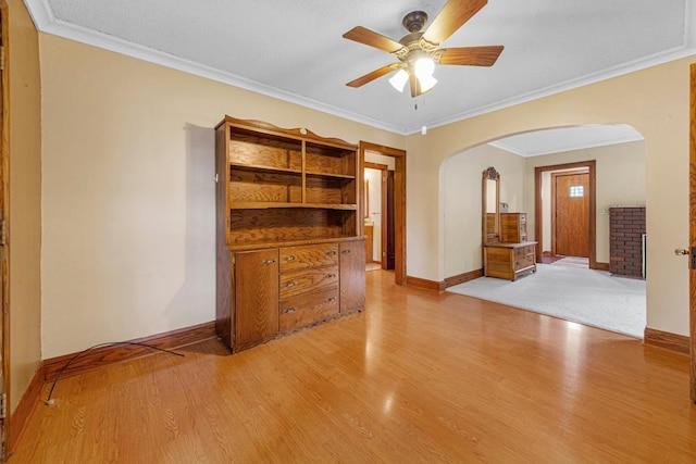 209 Main St, Arlington, MN 55307 - spare room with arched walkways, a ceiling fan, light wood-style flooring, ornamental molding, and baseboards