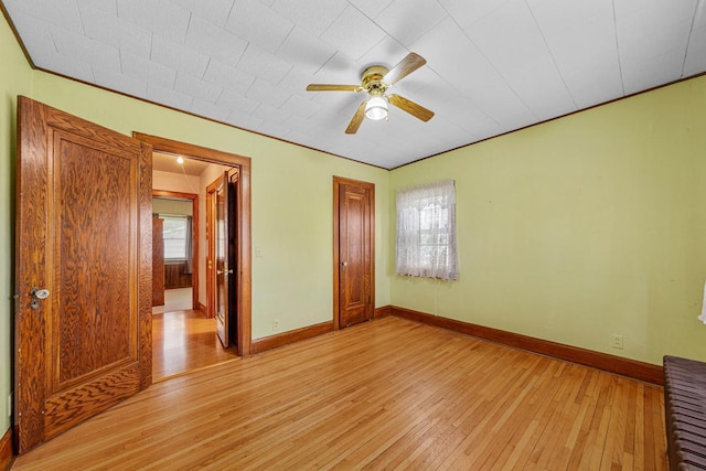 209 Main St, Arlington, MN 55307 - unfurnished bedroom featuring light wood-type flooring, baseboards, ceiling fan, and a closet