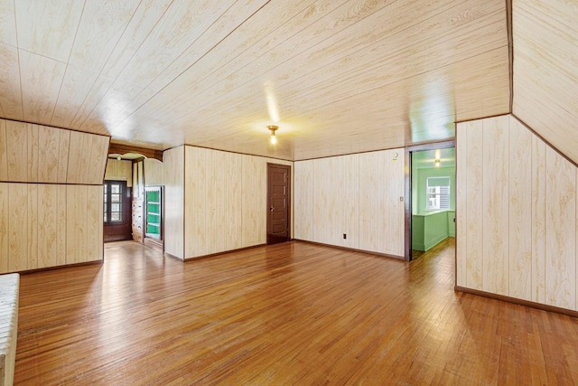 209 Main St, Arlington, MN 55307 - unfurnished room featuring light wood-type flooring, wooden walls, wood ceiling, and baseboards