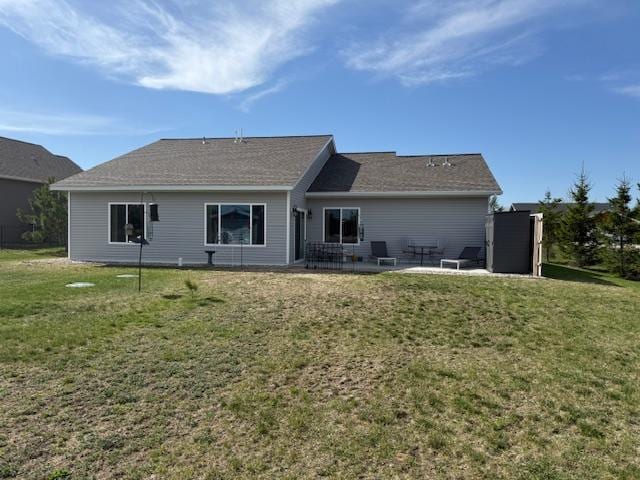 2008 Whiting Rd NW Unit 26, Bemidji, MN 56601 - rear view of house featuring a patio and a yard