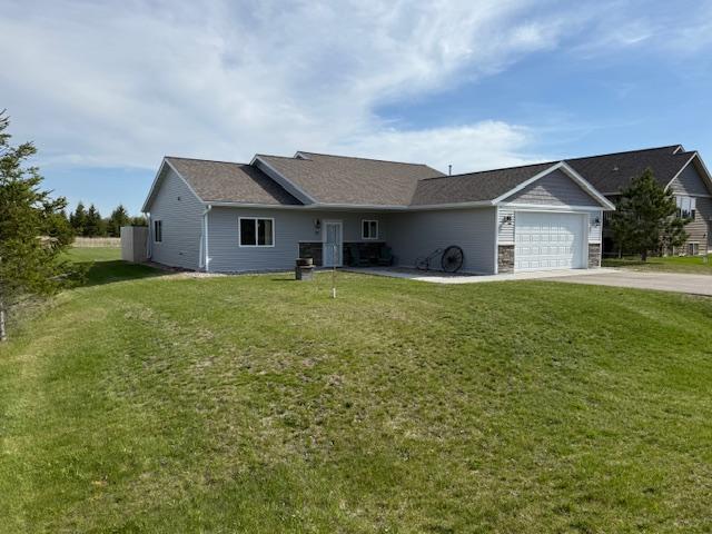 2008 Whiting Rd NW Unit 26, Bemidji, MN 56601 - single story home with concrete driveway, an attached garage, and a front lawn