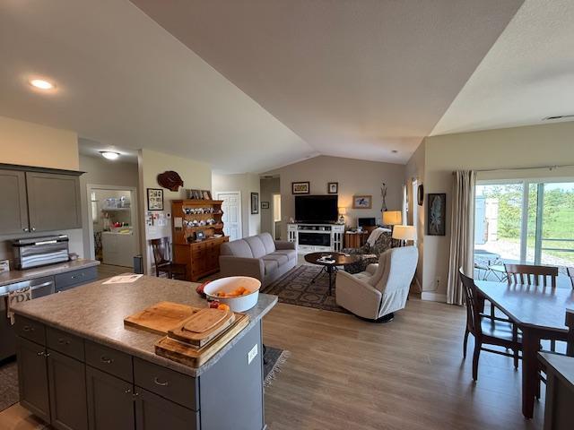 2008 Whiting Rd NW Unit 26, Bemidji, MN 56601 - living room featuring lofted ceiling, wood finished floors, baseboards, and recessed lighting
