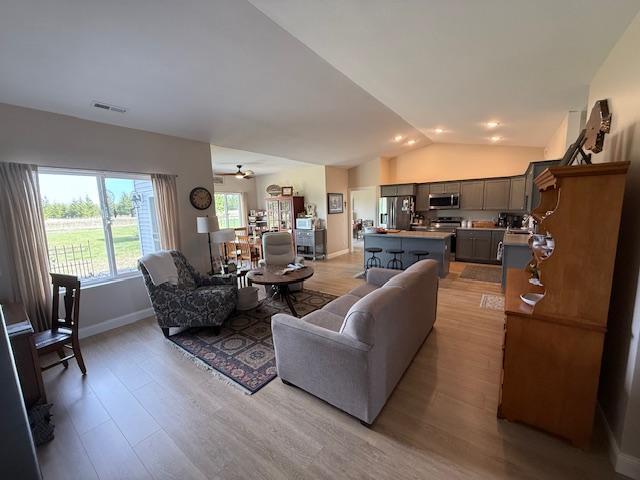 2008 Whiting Rd NW Unit 26, Bemidji, MN 56601 - living area with vaulted ceiling, light wood finished floors, baseboards, and a ceiling fan