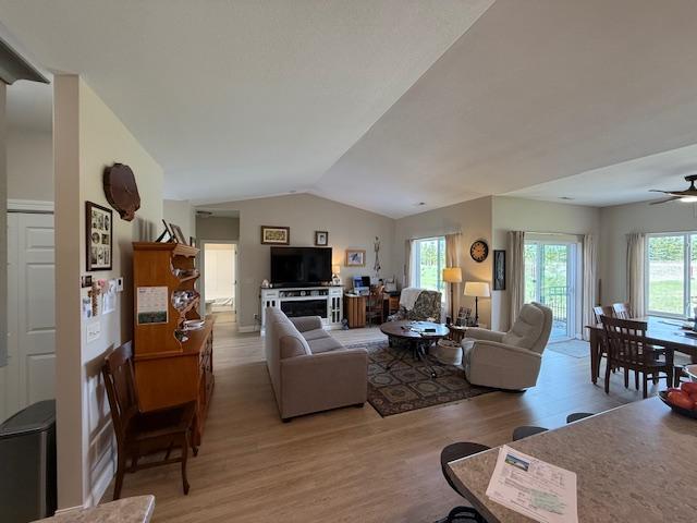 2008 Whiting Rd NW Unit 26, Bemidji, MN 56601 - living room with light wood-type flooring, vaulted ceiling, and a ceiling fan