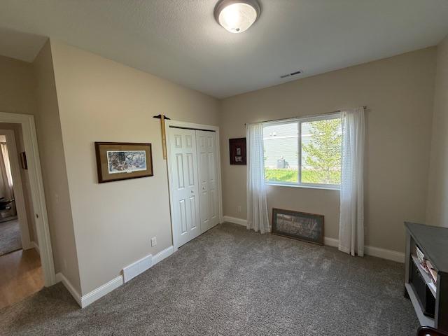 2008 Whiting Rd NW Unit 26, Bemidji, MN 56601 - unfurnished bedroom featuring carpet, baseboards, and a closet