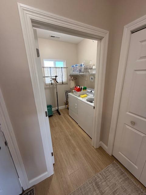 2008 Whiting Rd NW Unit 26, Bemidji, MN 56601 - laundry room featuring washer and clothes dryer, light wood finished floors, and baseboards