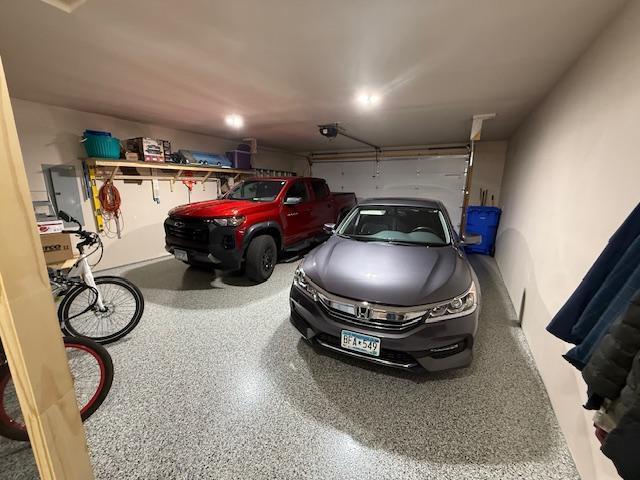 2008 Whiting Rd NW Unit 26, Bemidji, MN 56601 - garage featuring a garage door opener