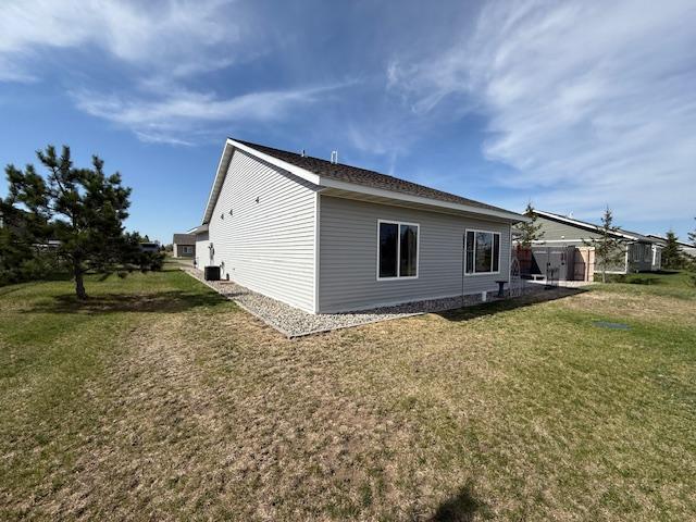 2008 Whiting Rd NW Unit 26, Bemidji, MN 56601 - view of home's exterior with a lawn and a storage unit