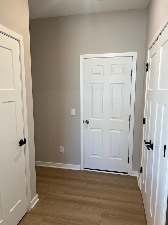 12608 Erskin St NE, Blaine, MN 55449 - hallway featuring wood finished floors and baseboards