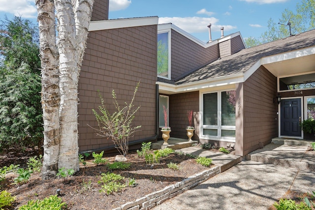 7676 Woodview Ct, Edina, MN 55439 - property entrance with a chimney and roof with shingles