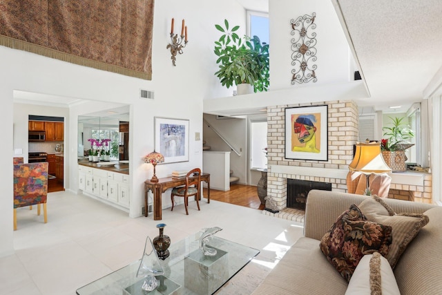 7676 Woodview Ct, Edina, MN 55439 - living room with stairway, plenty of natural light, a fireplace, and a high ceiling