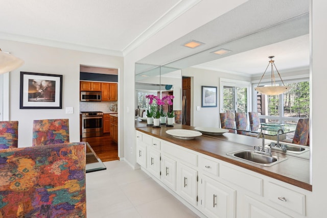 7676 Woodview Ct, Edina, MN 55439 - bathroom with a sink, ornamental molding, and tasteful backsplash