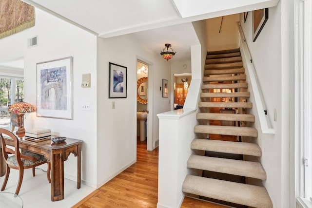 7676 Woodview Ct, Edina, MN 55439 - stairs with wood finished floors and baseboards