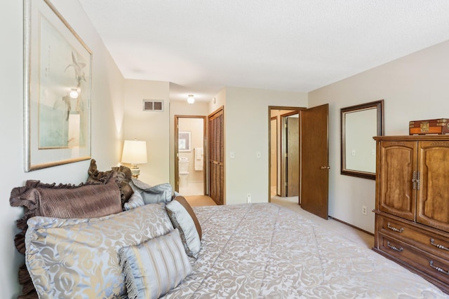 7676 Woodview Ct, Edina, MN 55439 - bedroom with connected bathroom, light colored carpet, a closet, and baseboards
