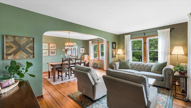 12586 220th St, Silver Lake, MN 55381 - living area with arched walkways, wood finished floors, and a chandelier