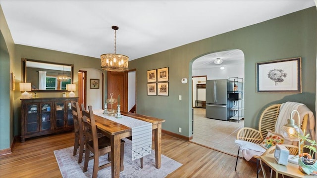12586 220th St, Silver Lake, MN 55381 - dining area featuring arched walkways, a chandelier, and light wood finished floors