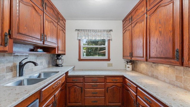 12586 220th St, Silver Lake, MN 55381 - kitchen featuring tasteful backsplash, light stone counters, and brown cabinets