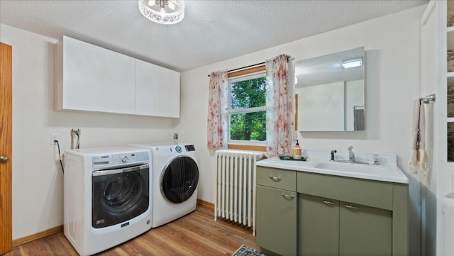 12586 220th St, Silver Lake, MN 55381 - laundry area with radiator, separate washer and dryer, light wood-style floors, and a textured ceiling