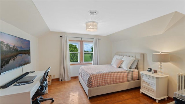 12586 220th St, Silver Lake, MN 55381 - bedroom with lofted ceiling, wood finished floors, a desk, and radiator