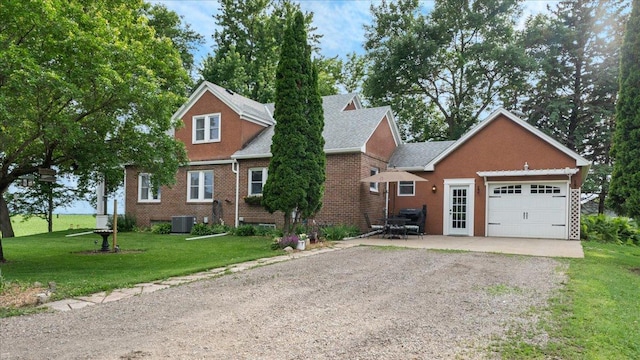 12586 220th St, Silver Lake, MN 55381 - view of front of house featuring gravel driveway, a front lawn, a garage, and brick siding