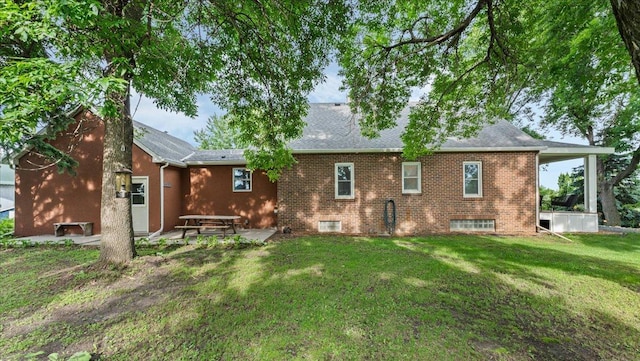 12586 220th St, Silver Lake, MN 55381 - rear view of house with a yard, a patio area, brick siding, and a shingled roof