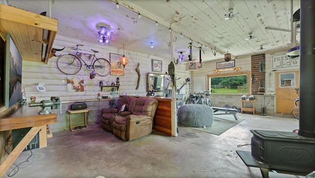 12586 220th St, Silver Lake, MN 55381 - living area featuring a wood stove, unfinished concrete flooring, and concrete block wall