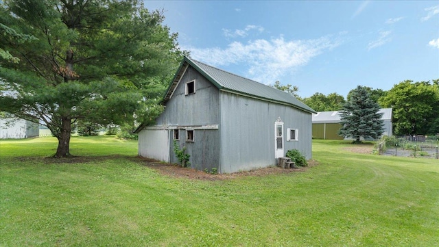 12586 220th St, Silver Lake, MN 55381 - view of home's exterior with a lawn, an outbuilding, and a metal roof