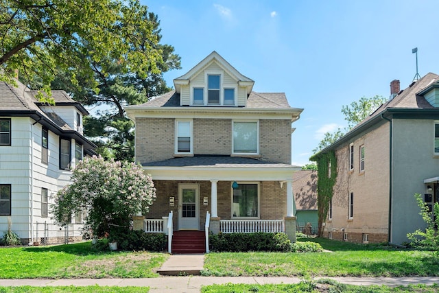 1123 5th St NE, Minneapolis, MN 55413 - traditional style home with brick siding, covered porch, and a front lawn