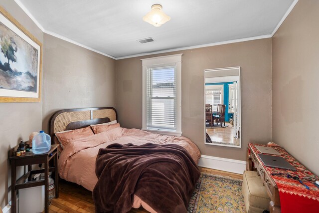 1123 5th St NE, Minneapolis, MN 55413 - bedroom featuring ornamental molding, baseboards, and wood finished floors