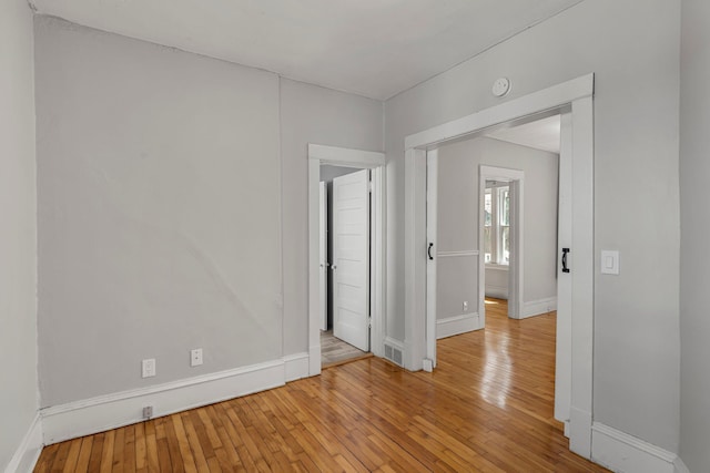 1123 5th St NE, Minneapolis, MN 55413 - spare room with baseboards, light wood-type flooring, and a smoke detector