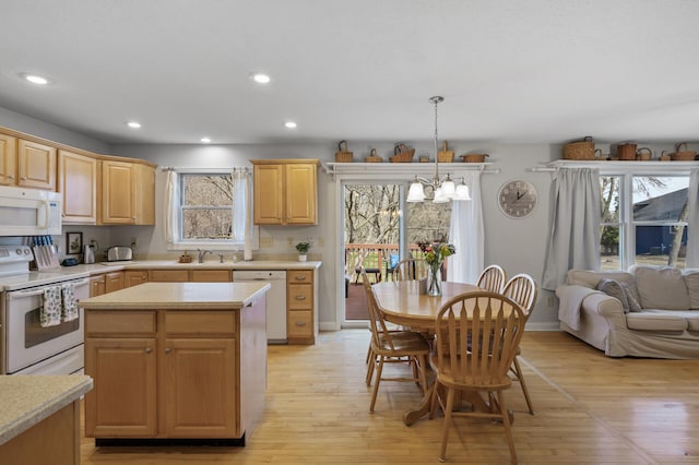 19062 180th Ave NW, Big Lake, MN 55309 - kitchen featuring white appliances, light brown cabinetry, light countertops, light wood-style floors, and a chandelier