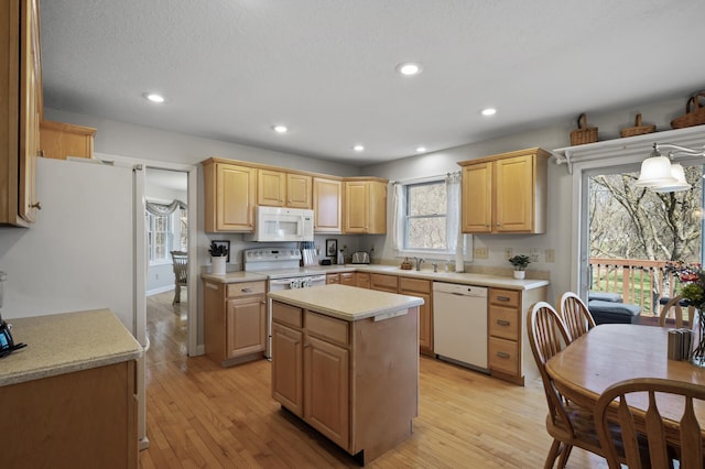 19062 180th Ave NW, Big Lake, MN 55309 - kitchen with white appliances, light countertops, light brown cabinets, a sink, and recessed lighting